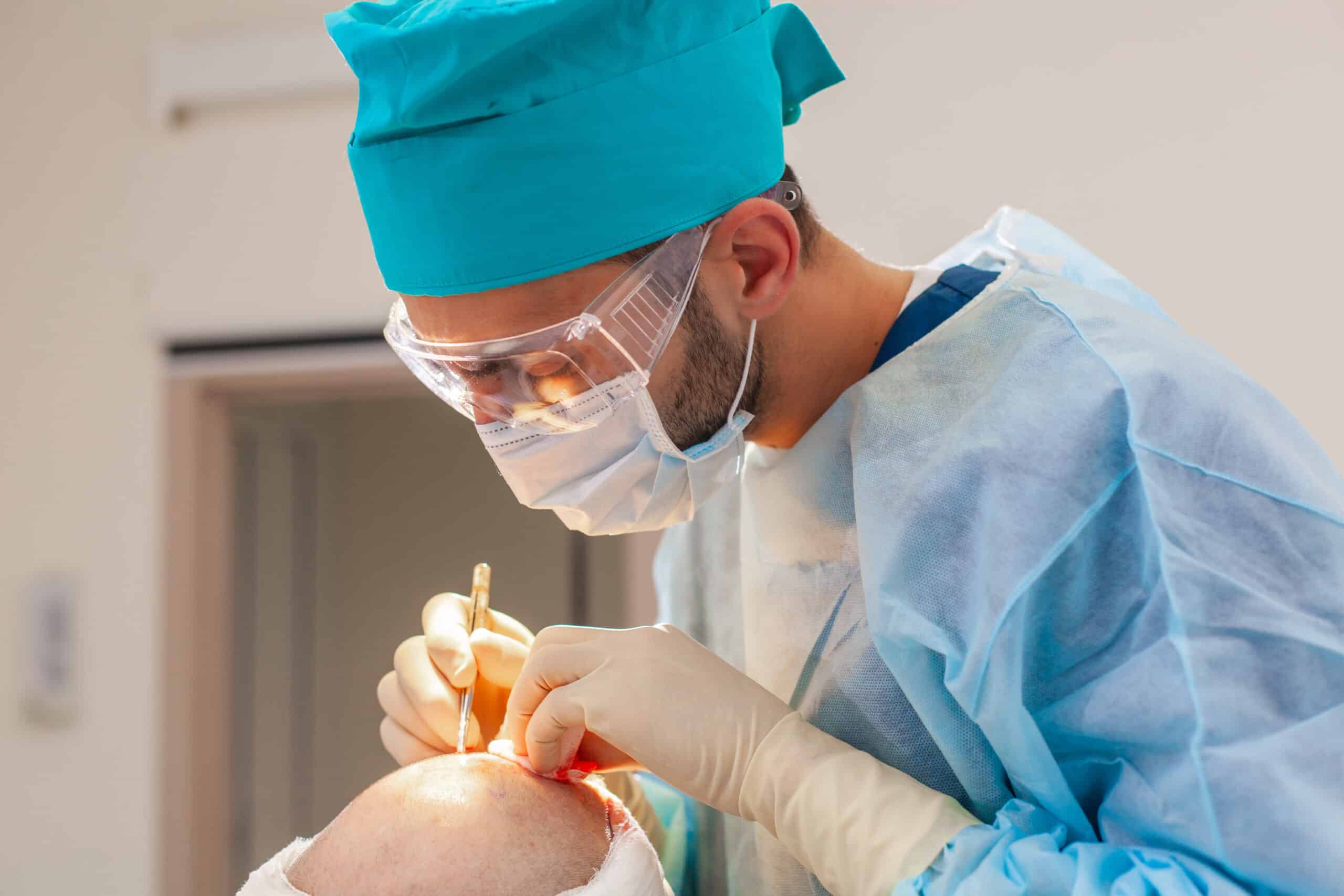 surgeon performing hair transplant surgery under a bright light