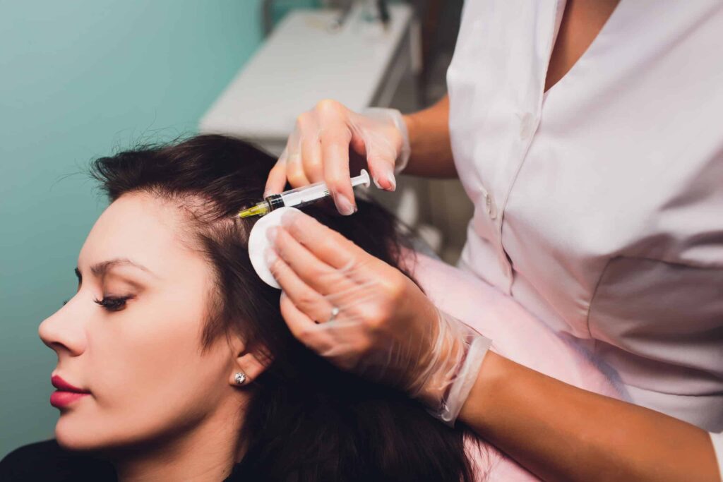 Woman receiving a PRP injection in her thinning hairline