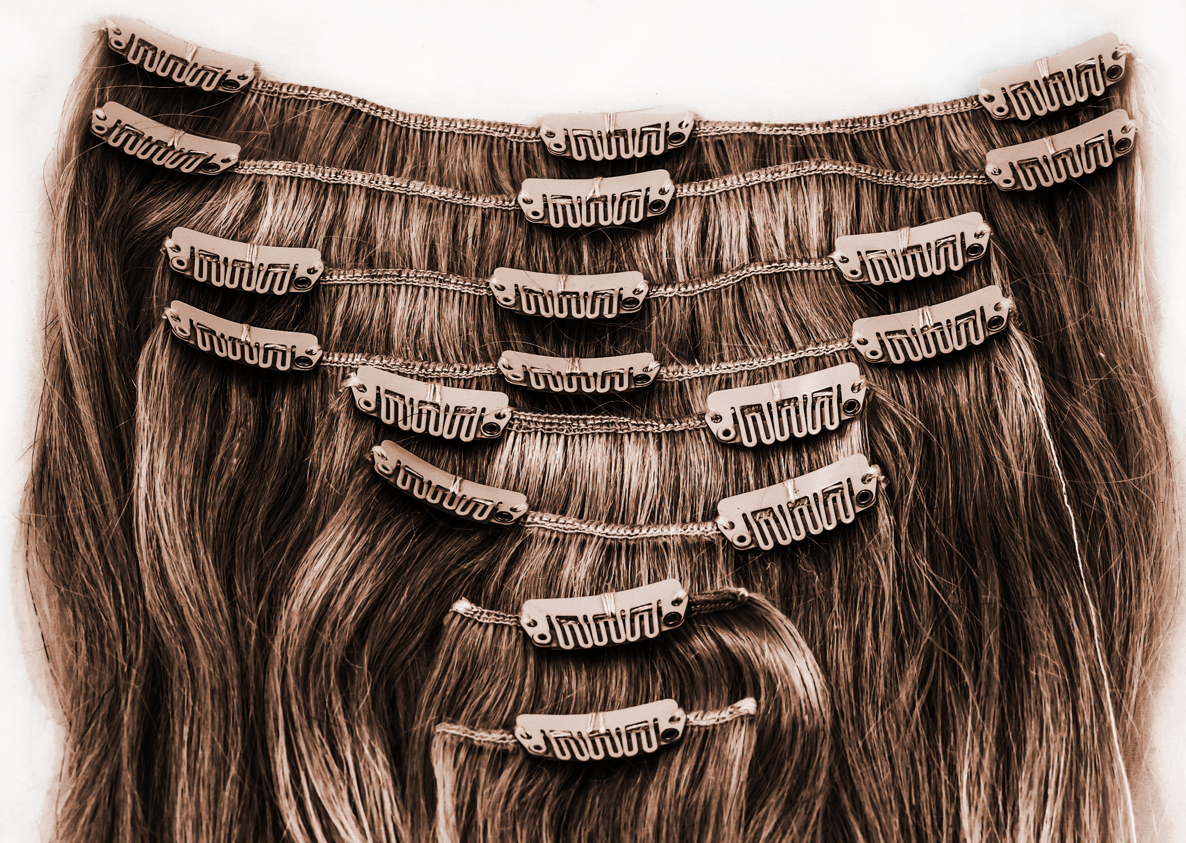 brunette clip in hair extensions shown on a white background